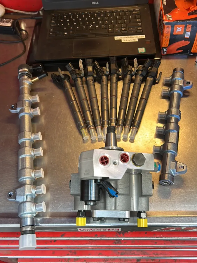 Ford diesel injectors, fuel rails and high-pressure pump laid out at Too-Big Performance in Rocklin, CA